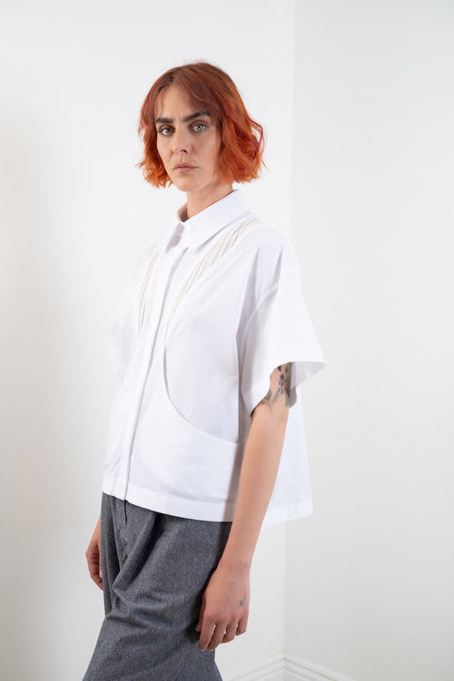 Chemise Christine blanche portée, silhouette structurée et féminine, col chemise et bas asymétrique, création française, 100% coton, popeline – Onarch